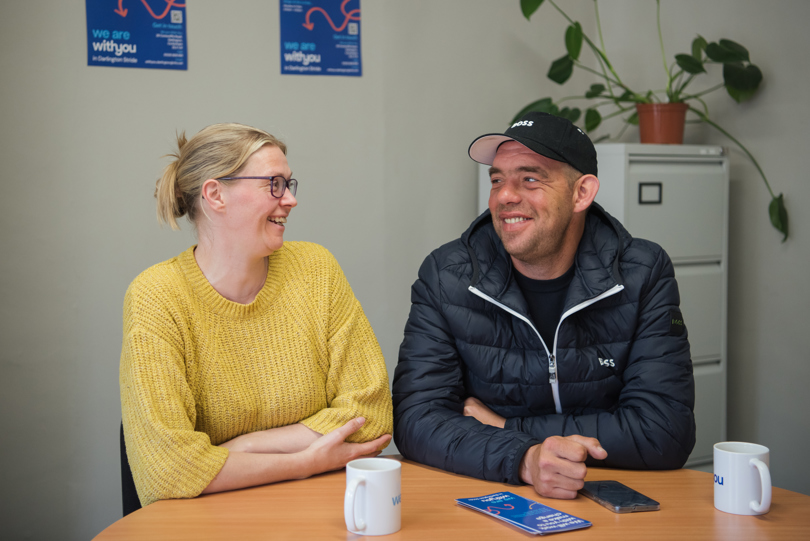 Phil with his partner Anne-Marie (left), laughing and smiling