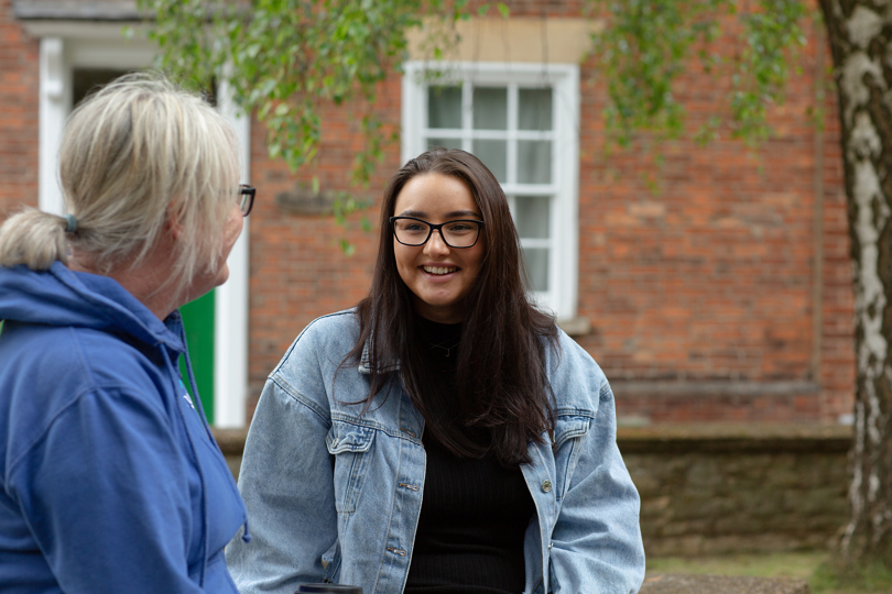 Beth, chatting and laughing with her Key Worker, Angela